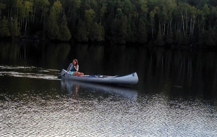 Paddling a canoe on a lake