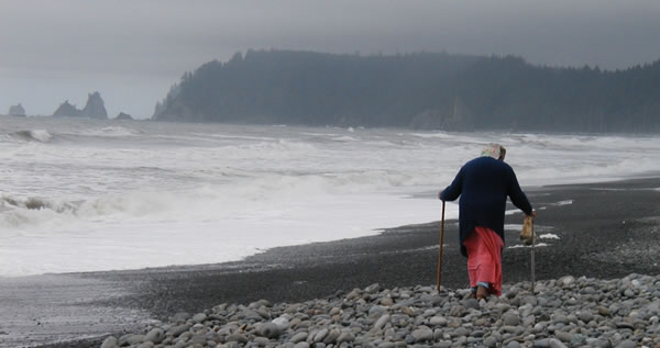 Woman walking on rocky beach